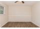 An empty room with hardwood floors has neutral paint and a ceiling fan at 1026 Eisenhower Se Ct, Atlanta, GA 30354