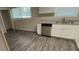 Modern kitchen featuring stainless steel appliances, granite countertops, and new floors at 1026 Eisenhower Se Ct, Atlanta, GA 30354