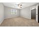Bedroom showcasing neutral walls, carpet flooring, a ceiling fan, and a window with blinds at 1192 Melton Sw Dr, Lilburn, GA 30047