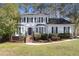 Charming two-story home with a landscaped front yard, black shutters, and a welcoming entrance at 1192 Melton Sw Dr, Lilburn, GA 30047
