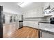 Modern kitchen featuring white cabinets, stainless steel appliances, and hardwood flooring at 1192 Melton Sw Dr, Lilburn, GA 30047