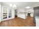 Well-lit kitchen with a dining area, granite countertops, stainless steel appliances, and modern fixtures at 1192 Melton Sw Dr, Lilburn, GA 30047