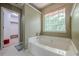 Bathroom with soaking tub, walk-in shower, and a glimpse into the walk-in closet at 2563 Creek Ter, Snellville, GA 30078