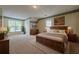 Spacious bedroom featuring elegant decor, large windows, and hardwood furniture at 2563 Creek Ter, Snellville, GA 30078