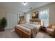 Comfortable bedroom with natural wood furnishings, decorative artwork, and natural light at 2563 Creek Ter, Snellville, GA 30078