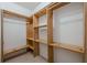 Walk-in closet featuring natural wood shelving and ample storage space at 2563 Creek Ter, Snellville, GA 30078