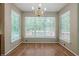 Sun-filled dining area featuring wood floors and contemporary chandelier at 2563 Creek Ter, Snellville, GA 30078