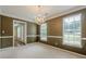 Formal dining room featuring neutral carpet, crown molding, and chandelier at 2563 Creek Ter, Snellville, GA 30078