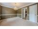 Spacious dining room with a chandelier and neutral colors. Natural light from windows at 2563 Creek Ter, Snellville, GA 30078