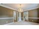 Large dining room featuring neutral carpet, crown molding, and chandelier at 2563 Creek Ter, Snellville, GA 30078