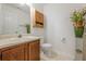 Bright half bathroom featuring a decorative vase and small cabinet at 2563 Creek Ter, Snellville, GA 30078
