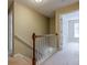 Bright hallway with carpeted floors and a classic wooden banister leading to the next floor at 2563 Creek Ter, Snellville, GA 30078