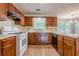 Spacious kitchen with wood cabinets, a double basin sink, and modern appliances at 2563 Creek Ter, Snellville, GA 30078