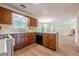 A bright kitchen with wood cabinets, white countertops and open access to other rooms at 2563 Creek Ter, Snellville, GA 30078