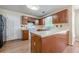 Traditional-style kitchen with wood cabinets, laminate countertops, and modern appliances at 2563 Creek Ter, Snellville, GA 30078