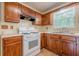 A well-lit kitchen with wood cabinets, white countertops, and modern gas range at 2563 Creek Ter, Snellville, GA 30078
