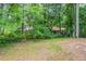 View of backyard featuring mature shade trees and green grass at 4164 Little Nw Spgs, Kennesaw, GA 30144