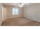 This bedroom features neutral walls, carpet flooring, a ceiling fan, and a window at 4164 Little Nw Spgs, Kennesaw, GA 30144