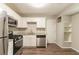 Bright kitchen featuring stainless steel appliances, wooden floors, white cabinets and granite countertops at 4164 Little Nw Spgs, Kennesaw, GA 30144