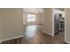 Open-concept living space featuring stylish wood flooring and view to the kitchen at 4164 Little Nw Spgs, Kennesaw, GA 30144