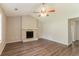Spacious living room with a decorative stone fireplace and wood-look flooring at 4164 Little Nw Spgs, Kennesaw, GA 30144