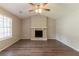 Bright living room featuring a stone fireplace and wood-look flooring at 4164 Little Nw Spgs, Kennesaw, GA 30144