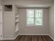 Bright room with built-in shelving and a window, featuring wood-look flooring at 4164 Little Nw Spgs, Kennesaw, GA 30144