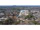 Beautiful aerial shot of a development neighborhood with surrounding mature landscape and inset of home at 4420 Ross Estates Ct, Snellville, GA 30039