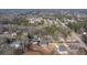 Scenic aerial view showcasing a residential neighborhood with mature trees and well-maintained homes at 4420 Ross Estates Ct, Snellville, GA 30039