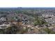 Stunning aerial view of a neighborhood with a mountain backdrop, surrounded by lush green trees at 4420 Ross Estates Ct, Snellville, GA 30039