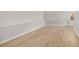 Spacious basement area with light hardwood flooring, ready for customization and finishing at 4420 Ross Estates Ct, Snellville, GA 30039
