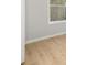 Bright bedroom with light-colored hardwood floors and a window providing natural light at 4420 Ross Estates Ct, Snellville, GA 30039