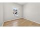 A clean bedroom featuring hardwood floors, a window and neutral walls at 4420 Ross Estates Ct, Snellville, GA 30039