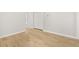 Clean bedroom showcasing light hardwood floors and clean white trim details throughout at 4420 Ross Estates Ct, Snellville, GA 30039