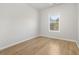 Bright bedroom featuring a window, hardwood floors and neutral walls at 4420 Ross Estates Ct, Snellville, GA 30039