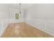 Empty dining room with hardwood floors, decorative molding, and a modern light fixture at 4420 Ross Estates Ct, Snellville, GA 30039