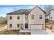 Charming two-story brick home featuring an attached two-car garage and manicured front yard at 4420 Ross Estates Ct, Snellville, GA 30039