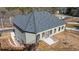 View of back and side of home, showing the concrete patio, light-grey siding, and windows at 4420 Ross Estates Ct, Snellville, GA 30039