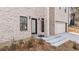 Exterior shot of the front entrance and garage of a painted brick, two story home at 4420 Ross Estates Ct, Snellville, GA 30039