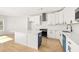 Bright kitchen boasts white cabinets, stainless steel appliances, and a breakfast bar at 4420 Ross Estates Ct, Snellville, GA 30039