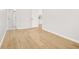 Bright living room showcasing light hardwood floors and clean white trim details throughout at 4420 Ross Estates Ct, Snellville, GA 30039