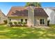 Well-manicured backyard with lush green grass, shrubbery and a beige exterior of the house at 64 Harbour Lake Dr, Fayetteville, GA 30215