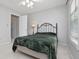 This bedroom is cozy with neutral carpet, a metal bed frame, and lots of natural light at 64 Harbour Lake Dr, Fayetteville, GA 30215