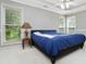 Bright bedroom features a ceiling fan, carpeted floors, and three windows overlooking a lawn at 64 Harbour Lake Dr, Fayetteville, GA 30215