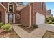 Brick home featuring a well-maintained front yard, mulched flower bed and a two-car garage at 64 Harbour Lake Dr, Fayetteville, GA 30215