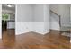 Elegant hallway with hardwood floors, staircase and white trim, leading to the kitchen at 64 Harbour Lake Dr, Fayetteville, GA 30215