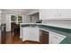 Cozy kitchen featuring white cabinets, stainless steel appliances and a sink with green countertops at 64 Harbour Lake Dr, Fayetteville, GA 30215