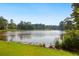 A serene pond reflects the surrounding trees and sky on a clear day at 64 Harbour Lake Dr, Fayetteville, GA 30215