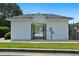 Exterior of a pool house with a gated entrance in a fenced in area and green grass at 64 Harbour Lake Dr, Fayetteville, GA 30215