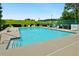 This outdoor pool is bright blue, surrounded by white lounge chairs and lush green grass at 64 Harbour Lake Dr, Fayetteville, GA 30215